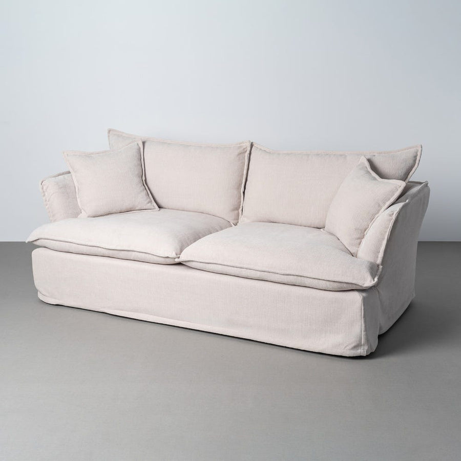Canapé trois places déhoussable en tissu polyester clair, couleur crème